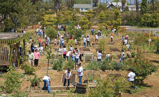 Students, parents and teachers work in Los Angeles’ 24th Street Elementary School garden during Big Sunday, a citywide community service event.
